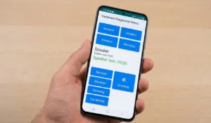close-up view of an Android phone screen displaying the specialized white-and-blue #0# hardware diagnostic menu, where the speaker test is active and passes